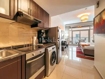 a kitchen with a sink and a stove top oven at Comfortable Fully Furnished Studio l Ideal Living Space in Dubai