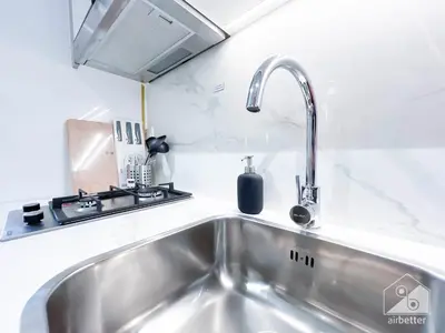 a kitchen with a sink and a faucet at Urban Charm Studio with Balcony in Riviera in Dubai