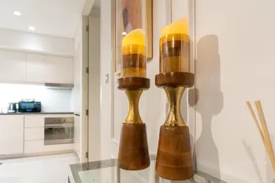 a cluster of lights on a glass table in a kitchen at Skyline Burj Facing Suite in Dubai