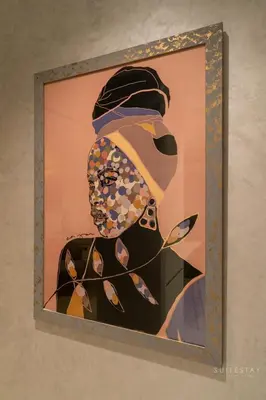a painting of a woman with a hat at Skyline Burj Facing Suite in Dubai