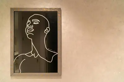 a painting of a man on a wall at Skyline Burj Facing Suite in Dubai