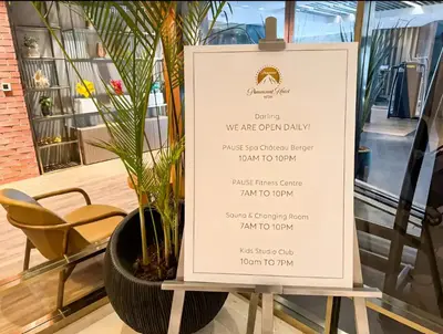 a menu on a stand next to a plant at Burj Khalifa Downtown Views - Highest Infinity Pool in Downtown in Dubai