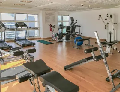 a gym with several treadmills and exercise machines at Stunning Apartment - High Floor - Canal View - Goldcrest Exectutive Tower in Dubai