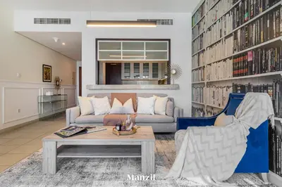 a living room with a couch and a table at Stylish 2BR with Burj Khalifa View near Dubai Mall in Dubai