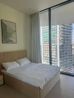 a bedroom with a bed and a large window at Ramadan Staycation offers Miracle Home Haven in Dubai
