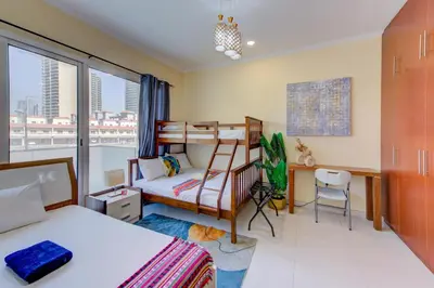 a bedroom with a bunk bed and a desk at Ramadan Staycation offers Miracle Home Haven in Dubai