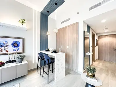 a kitchen with a bar and stools at Meydan Living - Unwavering Excellence in Dubai