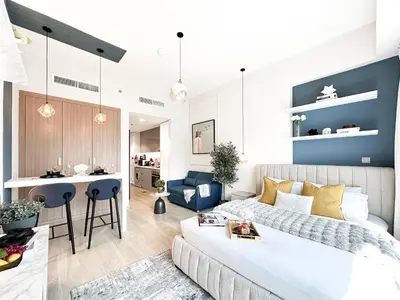 a bedroom and living room with a bed and a kitchen at Meydan Living - Unwavering Excellence in Dubai