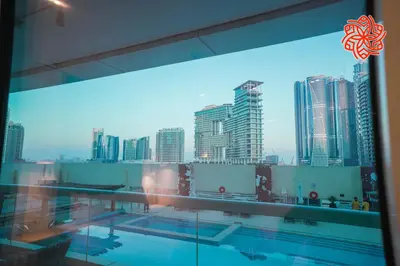 a view of a city skyline from a building with a pool at Alashrafia Saray- Classy 1BDR apartment in Canal Views in Dubai