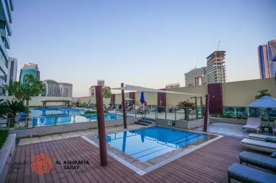 a pool on the roof of a building at Alashrafia Saray- Classy 1BDR apartment in Canal Views in Dubai