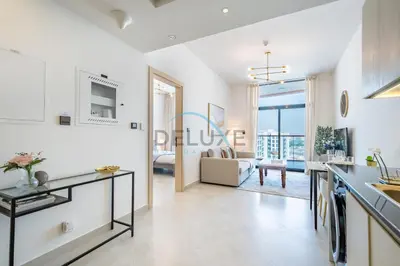 a kitchen and living room with a view of a living room at Lovely 1BR in Binghatti Avenue Al Jaddaf by Deluxe Holiday Homes in Dubai