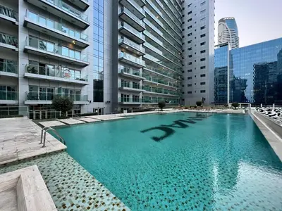 a swimming pool in a city with tall buildings at GuestReady - Charming studio in Business Bay in Dubai