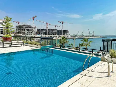 a swimming pool on top of a building at HiGuests - Beachfront Living Stunning 4 BR with Maid's Room in Dubai