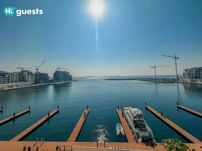 a boat is docked at a dock in a river at HiGuests - Beachfront Living Stunning 4 BR with Maid's Room in Dubai