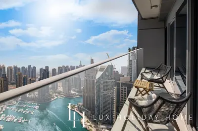 a balcony with two chairs and a view of the city at LUX Lavish Suite with Full Marina View 4 in Dubai