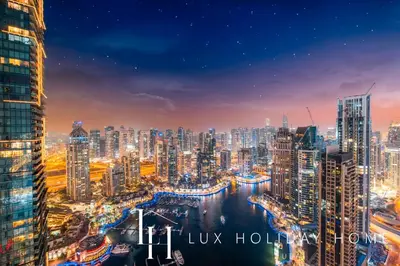 a view of a city skyline at night at LUX Lavish Suite with Full Marina View 4 in Dubai