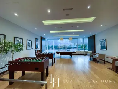 a living room with a pool table and ping pong tables at LUX Lavish Suite with Full Marina View 4 in Dubai