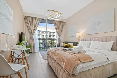 a bedroom with a large bed and a living room at luxury Santorini studio style in Dubai