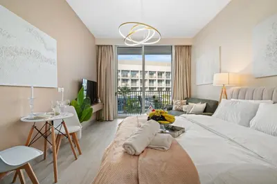 a living room with a large white bed and a table at luxury Venice holiday home in Dubai