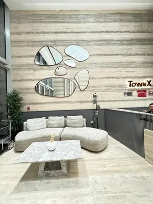 a living room with a couch and two mirrors at luxury Venice holiday home in Dubai