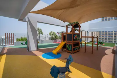 a play area with a slide and a playground at Spacious and Modern Studio -Great Facilities in Dubai