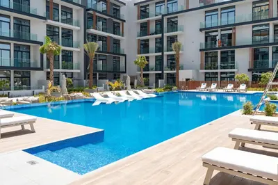 an image of a swimming pool in a apartment building at Spacious and Modern Studio -Great Facilities in Dubai