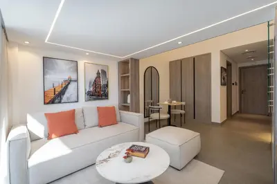 a living room with a white couch and a table at Trendy Loft Studio in Oxford Terrace JVC in Dubai