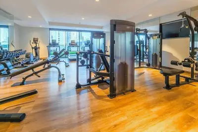 a gym with several treadmills and cardio machines at Dubai Opera - Luxury 2 Bedroom Apartment - Near Burj Khalifa in Dubai
