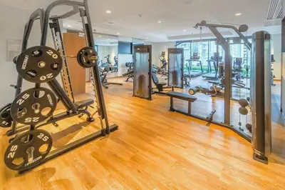 a gym with several treadmills and exercise machines at Dubai Opera - Luxury 2 Bedroom Apartment - Near Burj Khalifa in Dubai