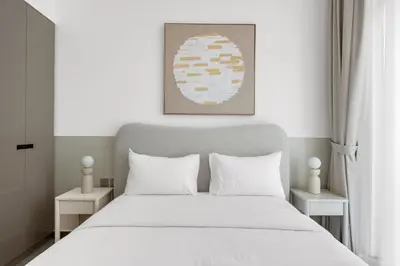 a bedroom with a large white bed with white pillows at 2BR Luxury Retreat - Stunning Canal and Sea View in Dubai