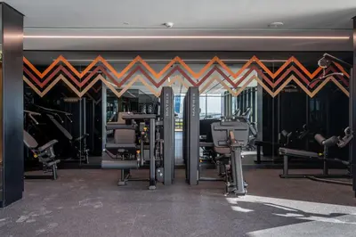 a gym with cardio equipment in a building at 2BR Luxury Retreat - Stunning Canal and Sea View in Dubai