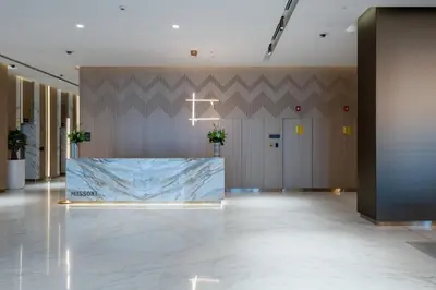 a lobby with a large marble table in the middle at 2BR Luxury Retreat - Stunning Canal and Sea View in Dubai