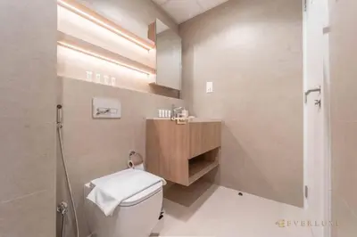 a bathroom with a toilet and a shower and a sink at Chic Liva 1br Family-friendly Great Amenities in Nadd Shubayḩ