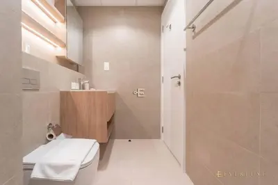 a bathroom with a toilet and a sink and a shower at Chic Liva 1br Family-friendly Great Amenities in Nadd Shubayḩ