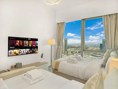 a hotel room with two beds and a large window at SmartStay at Grande Signature - Burj Khalifa View - 5 min Dubai Mall - Downtown Dubai - Brand New Luxury Apartments in Dubai