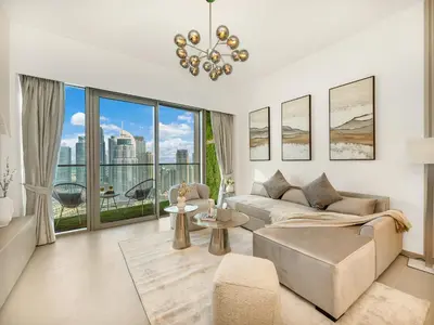 a living room with a couch and a large window at SmartStay at Grande Signature - Burj Khalifa View - 5 min Dubai Mall - Downtown Dubai - Brand New Luxury Apartments in Dubai