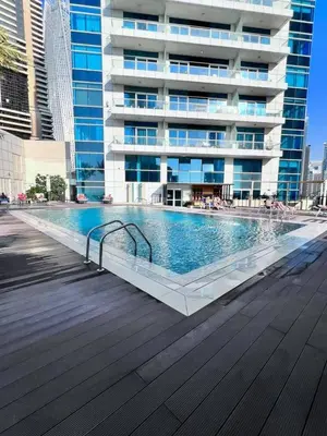 a swimming pool in front of a building at Stunning 1BR with Palm Jumeriah View in Marina in Dubai