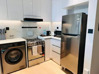 a kitchen with a stainless steel refrigerator and a dishwasher at Furnished 1br In Jvc Pool Access Free Parking in Dubai