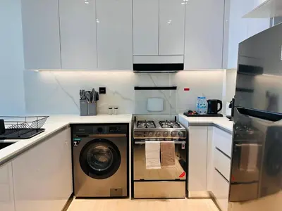 a kitchen with a washer and a dishwasher at Furnished 1br In Jvc Pool Access Free Parking in Dubai