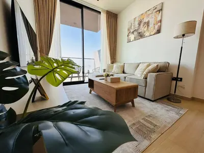 a living room with a couch and a table at Furnished 1br In Jvc Pool Access Free Parking in Dubai