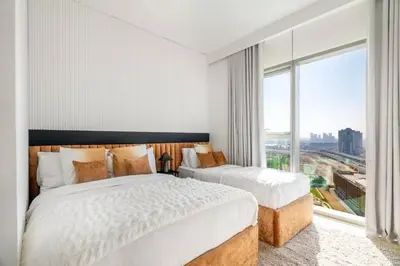 a bedroom with two beds and a large window at Prime Location Full Burj View in Downtown Dubai in Dubai