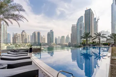 a pool in the middle of a city with tall buildings at GuestReady - Charm stay in Dubai Marina in Dubai
