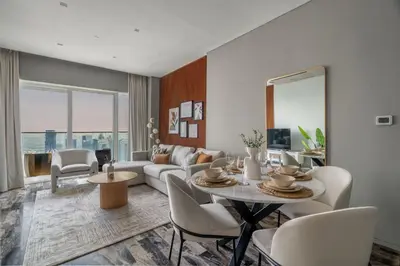 a living room with a couch and a table and chairs at GuestReady - Charm stay in Dubai Marina in Dubai