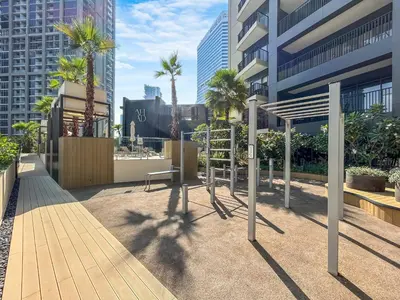 a playground in a city with palm trees and buildings at Exquisite Modern Home Minutes from Downtown Dubai in Dubai