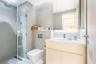 a bathroom with a toilet and a sink and a shower at Exquisite Modern Home Minutes from Downtown Dubai in Dubai