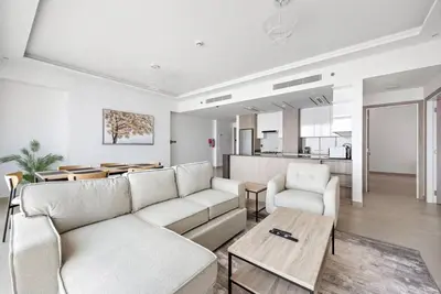 a living room with a couch and a table at 2-Bedroom Apartment in ME DO RE in Dubai