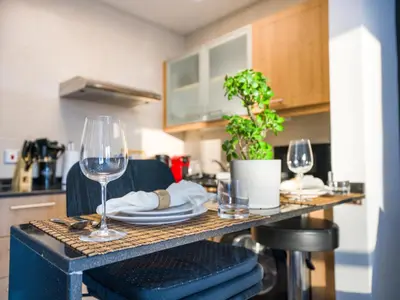 a table with two wine glasses and a plate at EasyGo- Comfy STU in Dubai Marina -Zum04 in Dubai