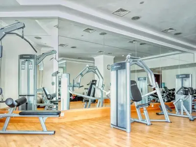 a gym with several tread machines and a mirror at Classic Retreat in JBR with Private Beach Access in Dubai