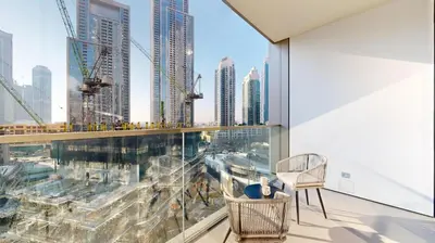 an apartment balcony with a view of a city at Grande Residence - Contemporary One Bedroom in Dubai