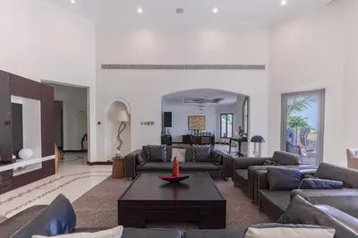 a living room with couches and a table at Private Pool & Direct Beach Access-4BDR Villa in Dubai